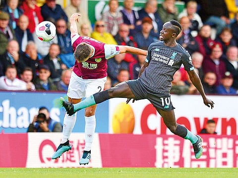 Burnley’s Matthew Lowton (left) and Liverpool’s Sadio Mane battle for the ball during the Premier League match at Turf Moor, Burnley. The reds beat Burnley 3-0.