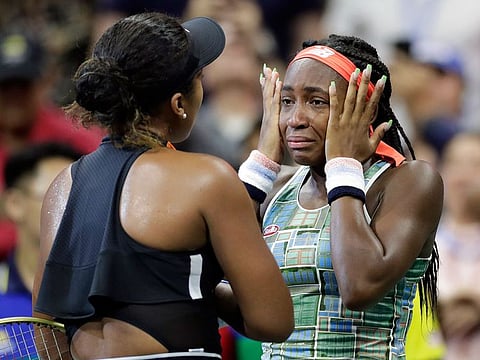 Coco Gauff wipes away tears while talking to Naomi Osaka, of Japan, after Osaka defeated Gauff during the third round of the U.S. Open tennis tournament Saturday, Aug. 31, 2019, in New York.