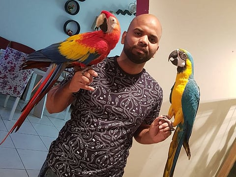 Nomaan Mohammed with Karishma (left) and Kareena (Right), his macaws