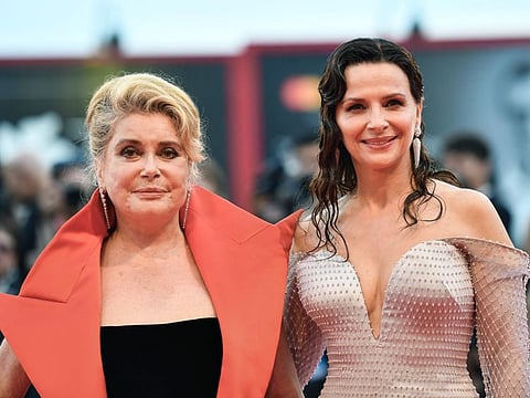 French actress Catherine Deneuve (L) and French actress Juliette Binoche arrive for the opening ceremony and the screening of the film "La Verite" (The Truth) presented in competition on August 28, 2019 during the 76th Venice Film Festival at Venice Lido. / AFP / Alberto PIZZOLI