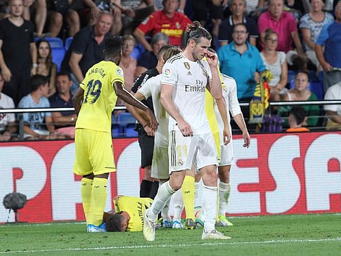 Real Madrid's Gareth Bale leaves the pitch after receiving a red card.