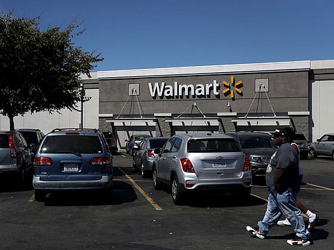 People walk outside a Walmart store in San Leandro, California.