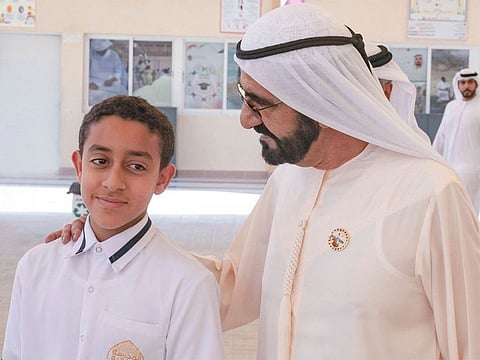 Sheikh Mohammed Bin Rashid with Khalifa Al Kaabi, the hero student who rescued his classmates after their bus caught fire on Tuesday in Kalba.