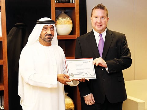 Sheikh Ahmad presents a certificate in honour of Norman Turnbull’s memory to his grandson Richard Gepp.