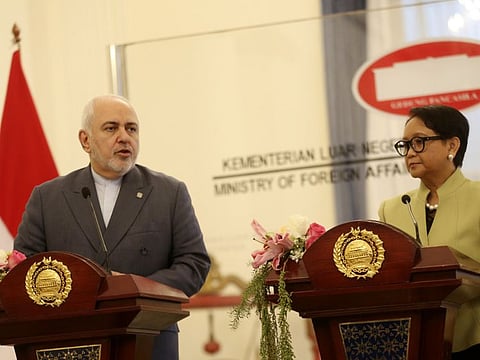 Iran's Foreign Minister Mohammad Javad Zarif, left, talks to journalist during a joint press conference with his Indonesian counterpart Retno Marsudi, right, after their meeting in Jakarta, Indonesia, Friday, Sept. 6, 2019