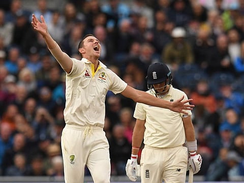 Australia's Josh Hazlewood (L) celebrates taking the wicket of England's captain Joe Root (R) on the third day of the fourth Ashes cricket Test match between England and Australia at Old Trafford in Manchester, north-west England on September 6, 2019.