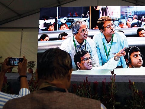 Live pictures of Indian Space Research Organization (ISRO) scientists reacting are displayed on a big screen at their Telemetry, Tracking and Command Network facility in Bangalore, India.
