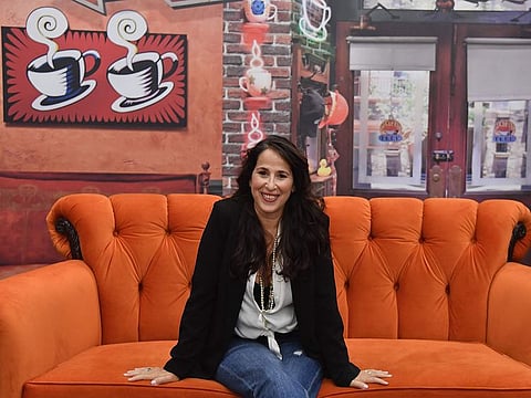 Actress Maggie Wheeler who played Janice on 'Friends' poses on the famous Central Perk couch during the Friends 25th Anniversary New York City Pop-Up press preview on September 05, 2019 in New York