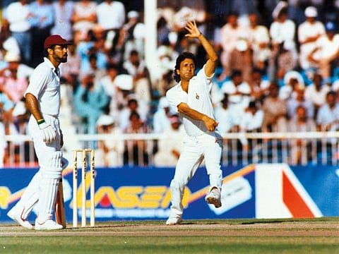 Abdul Qadir weaves his magic during a match in Sharjah. West Indies' wicketkeeper-batsman Jeff Dujon is at the non-striker's end.