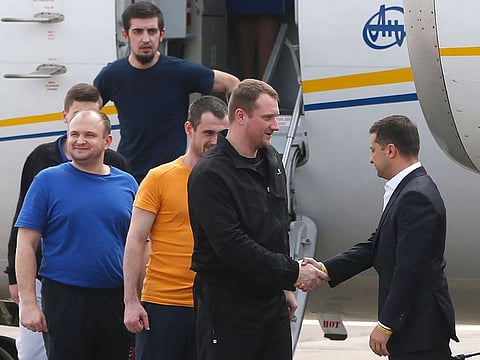 Ukraine's President Volodymyr Zelenskiy, right, greets Ukrainian prisoners upon their arrival at Boryspil airport, outside Kyiv, Ukraine, Saturday, Sept. 7, 2019.
