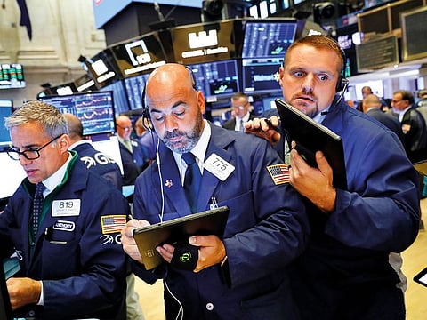 Traders on the floor at the New York Stock Exchange. Despite measures by central banks and governments across the globe to counter the economic toll of the coronavirus, analysts say they expect the panic to continue in equity markets, albeit at lower volatility.