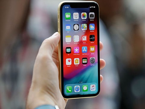 This Sept. 12, 2018, file photo shows an Apple iPhone XR on display at the Steve Jobs Theater after an event to announce new products, in Cupertino, California.