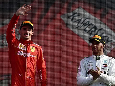 Winner Ferrari's Monegasque driver Charles Leclerc (L) celebrates next to third placed Mercedes' British driver Lewis Hamilton (R) on the podium after the Italian Formula One Grand Prix at the Autodromo Nazionale circuit in Monza on September 8, 2019.