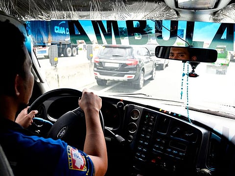 Ambulance driver Joseph Laylo driving along the South Luzon Expressway near Manila.