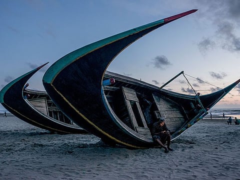 A Rohingya refugee using a phone to find out the whereabouts of his family and friends, in Shamlapur, Bangladesh