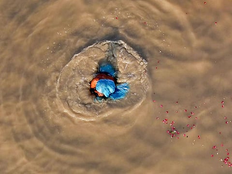 Allahabad: A woman takes a dip in the muddy water of River Ganga, in Allahabad, Wednesday, Sept 26, 2018. Image for illustrative purposes only