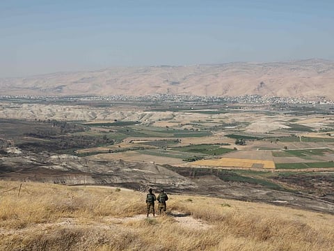 (FILES) In this file photo taken on June 23, 2019 Israeli soldiers stand guard in an old army outpost overlooking the Jordan Valley. Netanyahu issued a deeply controversial pledge on Tuesday to annex the Jordan Valley in the occupied West Bank if re-elected in September 17 polls