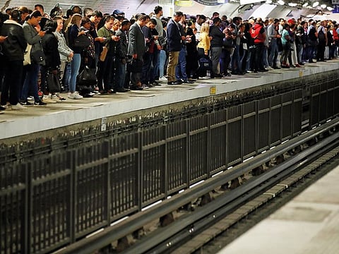 Commuters wait to board a metro at the Gare du Nord subway station during a strike by all unions of the Paris transport network (RATP) against pension reform plans in Paris, France.