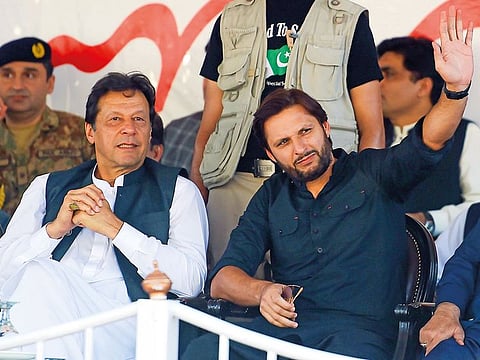 Prime Minister Imran Khan and former cricketer Shahid Afridi attend a rally in Muzaffarabad.