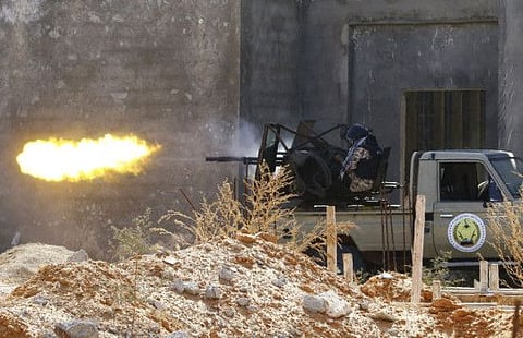 Fighters backing Government of National Accord (GNA) shoot a truck-mounted gun during clashes with forces loyal to Khalifa Haftar in the capital Tripoli's suburb of Ain Zara, on September 7, 2019