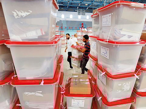 Polling agents in Tunis carry ballot boxes and election material to be distributed to voting booths, ahead of today’s presidential election.