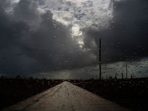 Rain prior to the arrival of the tropical depression falls on the windshield of a car in the aftermath of Hurricane Dorian at the route of Mclean's Town, Grand Bahama, Bahamas, Friday Sept. 13, 2019.