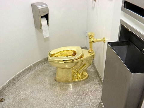 The 18-karat toilet, titled "America," by Maurizio Cattelan in the restroom of the Solomon R. Guggenheim Museum in New York