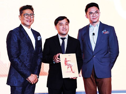 Paul Raymund Cortes receives the Eon Insight study from Junie del Mundo (left) and Mori Rodriguez in Dubai.