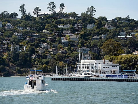 A boat motors toward the Corinthian Yacht Club in Tiburon, Calif., Monday, Sept. 16, 2019, with the town of Belvedere on the hill in the background.