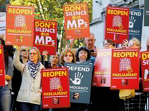 Demonstrators protest outside the Supreme court in central London on the first day of the hearing into the decision by the government to prorogue parliament.