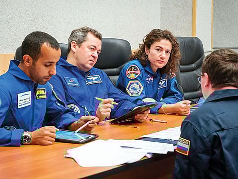 Hazza Al Mansouri (extreme left) attends a briefing session at the Cosmonaut Hotel crew quarters in Baikonur, Kazakhstan.