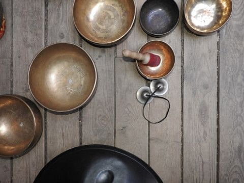 Singing bowls-Cup of life - popular mass product souvenir in Nepal, Tibet and India-stay on ethnic traditional wooden ornament. (Singing bowls-Cup of life - popular mass product souvenir in Nepal, Tibet and India-stay on ethnic traditional wooden orna