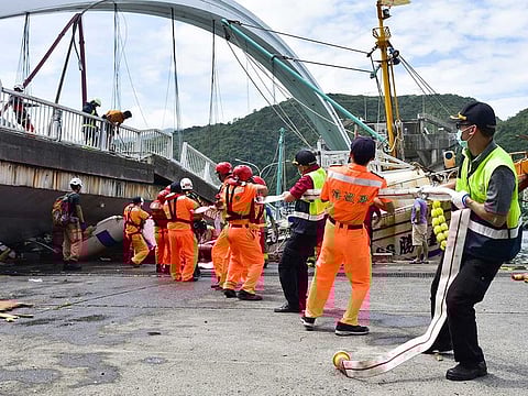 Rescuers work near the site of a collapsed bridge in Nanfangao, eastern Taiwan.