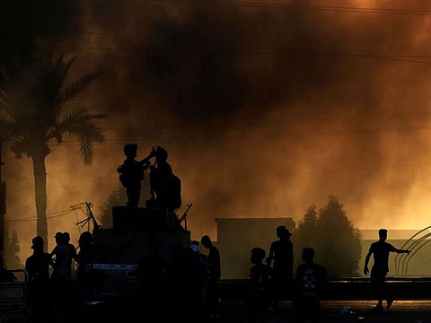 Iraqi security forces are seen as demonstrators take part in a protest over unemployment, corruption and poor public services in Baghdad, Iraq October 2, 2019.