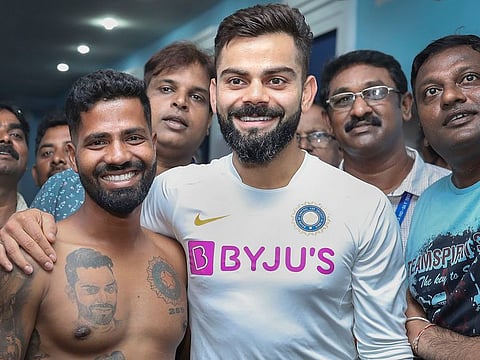 Virat Kohli poses for a photograph with his fan Pintu Behra after a pre-match press conference at Dr YS Rajasekhara Reddy ACA–VDCA Cricket Stadium, in Visakhapatnam.
