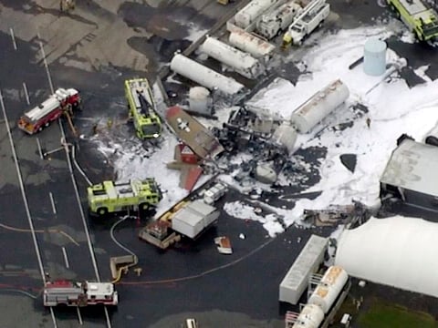 Emergency crews respond to where a Second World War-era bomber B-17 plane crashed at Bradley International Airport in Windsor Locks, Conn., Wednesday, Oct. 2, 2019.