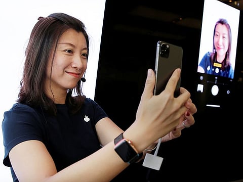 File photo: A staff member shows the new portrait shooting function for customers after Apple's new iPhone 11, 11 Pro and 11 Pro Max went on sale at the Apple Store in Beijing, China.