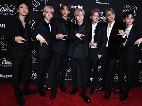Members of K-pop supergroup SuperM pose during a press conference at the Capitol Records Tower in Hollywood on October 3, 2019. / AFP / VALERIE MACON