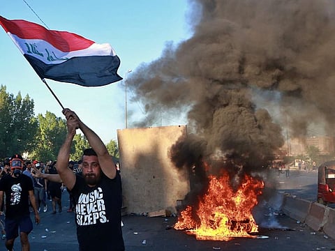 Anti-government protesters set fires during a demonstration in Baghdad on October 4, 2019.