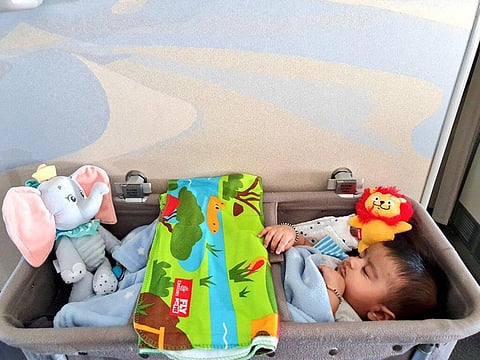 See baby Reyaansh tucked into a safe bassinet onboard an Emirates flight