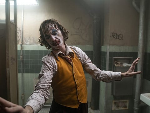 This image released by Warner Bros. Pictures shows Joaquin Phoenix in a scene from "Joker," in theaters on Oct. 4. (Niko Tavernise/Warner Bros. Pictures via AP)