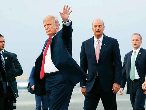 In this Tuesday, July 10, 2018, file photo, President Donald Trump is joined by Gordon Sondland, the U.S. ambassador to the European Union, second from right, as he arrives at Melsbroek Air Base, in Brussels, Belgium.