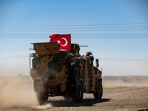 In this file photo taken on September 08, 2019 A Turkish military vehicle drives on a joint patrol with US troops in the Syrian village of al-Hashisha on the outskirts of Tal Abyad town on the border with Turkey.