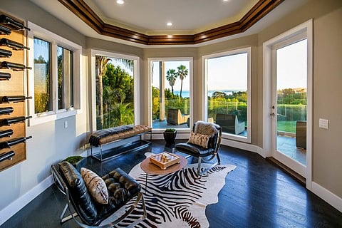 Comedian Russell Peters has leased out his home in Los Angeles' Maliu neighborhood, but is still trying to sell the 1.35-acre estate. The two-story home, now tenant-occupied until 2023, is now listed for $7.995 million, down from $8.8 million last year. The ocean-view home has 10,000 square feet of space, a movie theater and a gym. A wraparound terrace takes in the ocean. (Tyler Hogan/TNS)