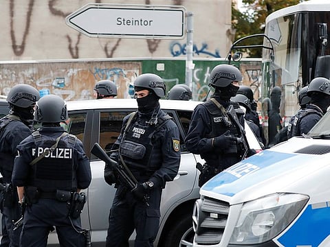 Police officers guard near the site of a shooting, in which two people were killed, in Halle, Germany October 9, 2019.