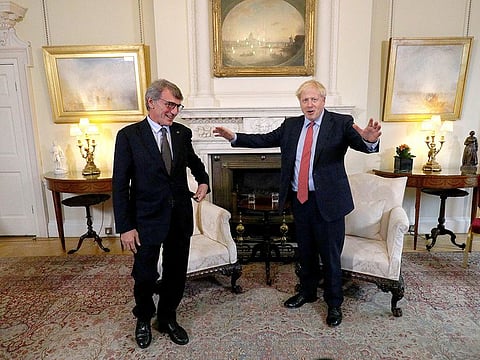 Britain's Prime Minister Boris Johnson, right, gestures as he stands with the President of the European Parliament David Sassoli, ahead of a private meeting in Downing Street, Tuesday Oct. 8, 2019.