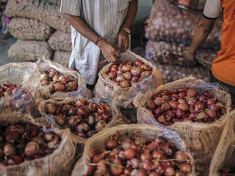 Bloomberg
A worker seals a sack of onions at a wholesale market in Mumbai on October 3.