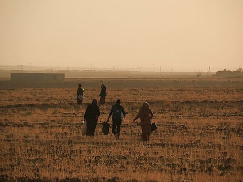 Syrians flee shelling by Turkish forces in Ras Al Ayn, northeast Syria, Wednesday, Oct. 9, 2019.
