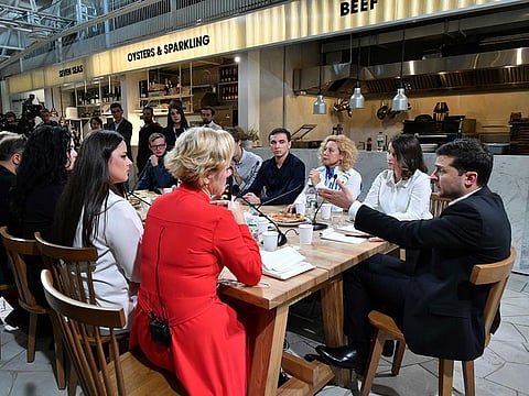 Ukrainian President Volodymyr Zelensky (R) speaks to media during his day-long media marathon at the Kiev's food court on October 10, 2019.