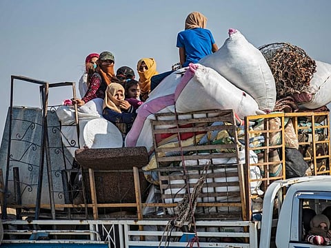 Syrian Arab and Kurdish civilians arrive to Tall Tamr town, in the Syrian northwestern Hasakeh province, after fleeing Turkish bombardment on the northeastern towns along the Turkish border on October 10, 2019.